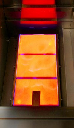 Sear burner showing  with orange, red, and purple hues on a dark background