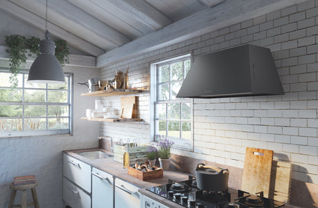Faber black Chloe wall mounted ventilation hood in a rustic kitchen with white tiled walls, wooden shelves, and stainless steel appliances